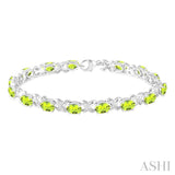 7x5 mm Oval Cut Peridot and 1/20 Ctw Round Cut Diamond Fashion Bracelet in Sterling Silver